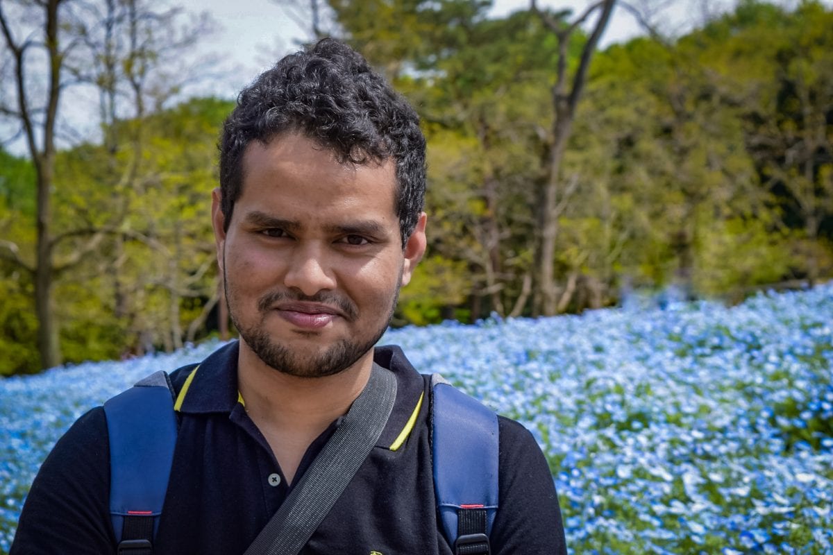 headshot of AMIT HASSAN